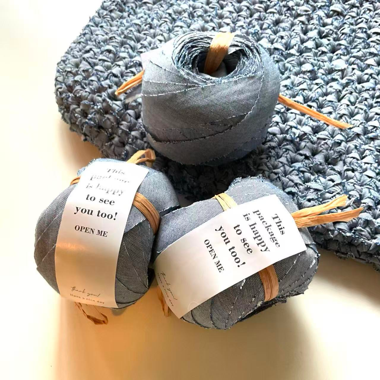Labeled balls of fabric yarn with a crocheted piece