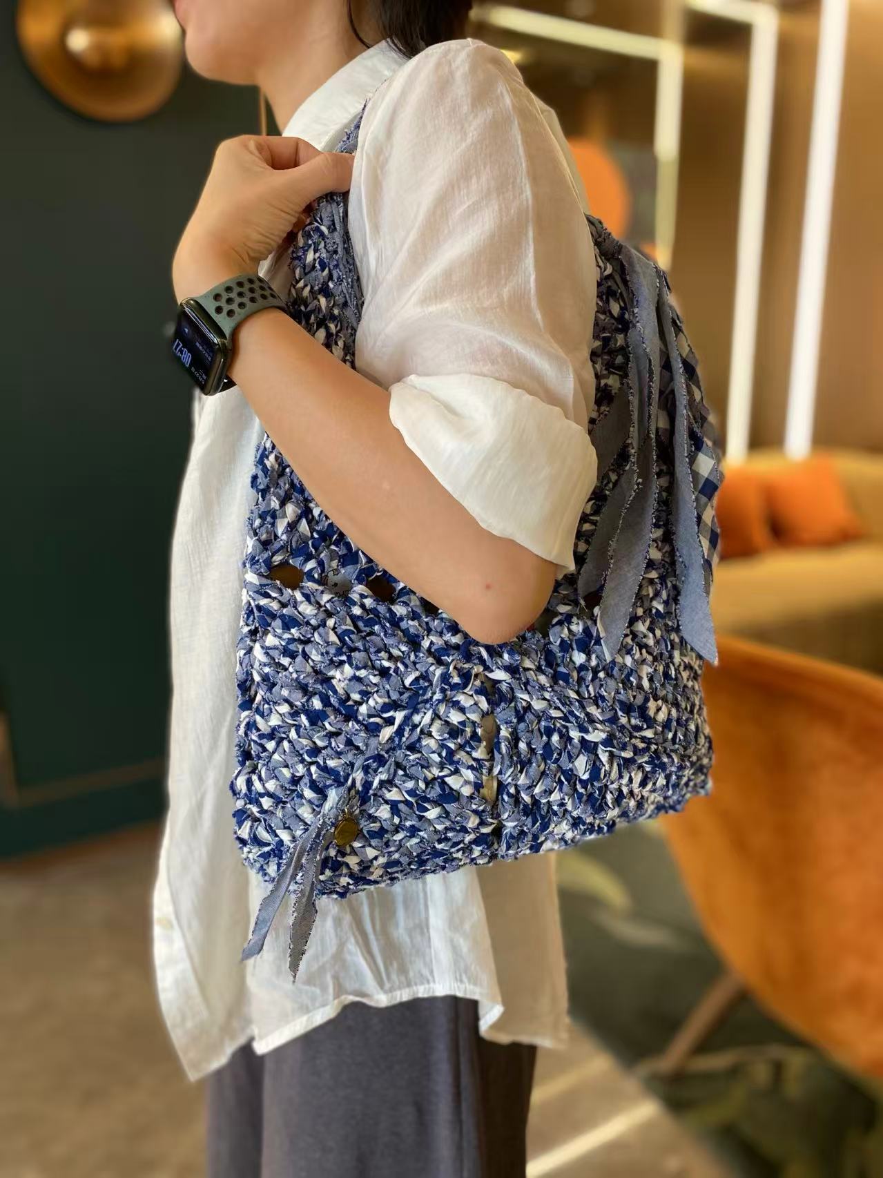 A bag made from fabric yarn, worn on the shoulder